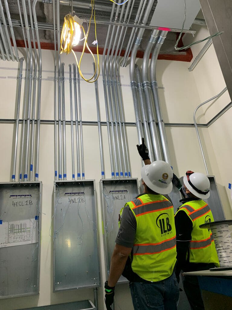Employees in electrical room